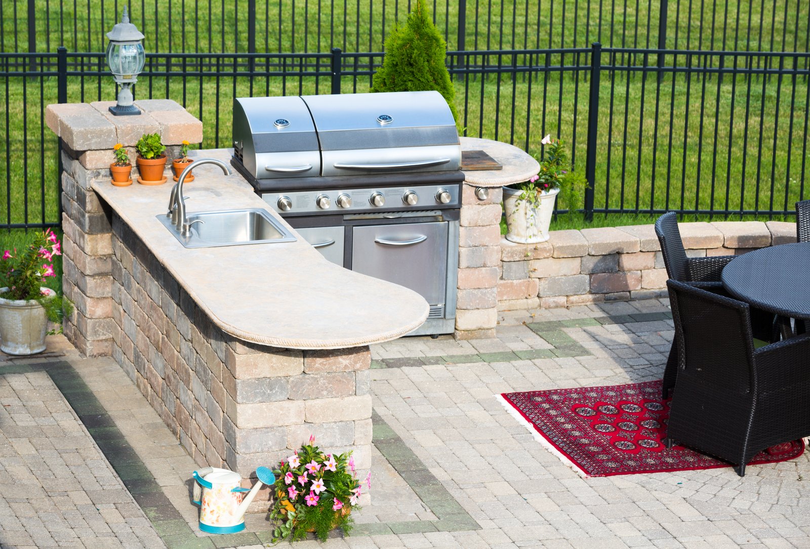 Stylish outdoor kitchen on a brick patio